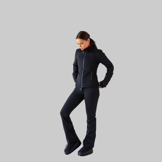 Woman wearing a black perfrmance ski outfit on a white background